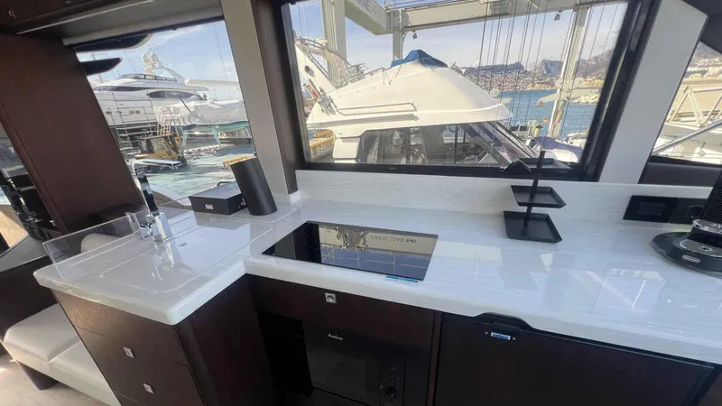 Yacht Photos Pics 2024 Galeon 410 HTC yacht interior with modern kitchen and marina view.