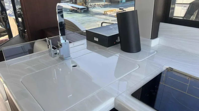  Yacht Photos Pics Modern kitchen area in 2024 Galeon 410 HTC yacht with sleek countertops and fixtures.