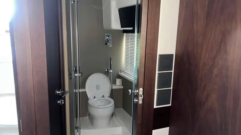  Yacht Photos Pics Modern bathroom in 2024 Galeon 410 HTC yacht with sleek design and glass door.