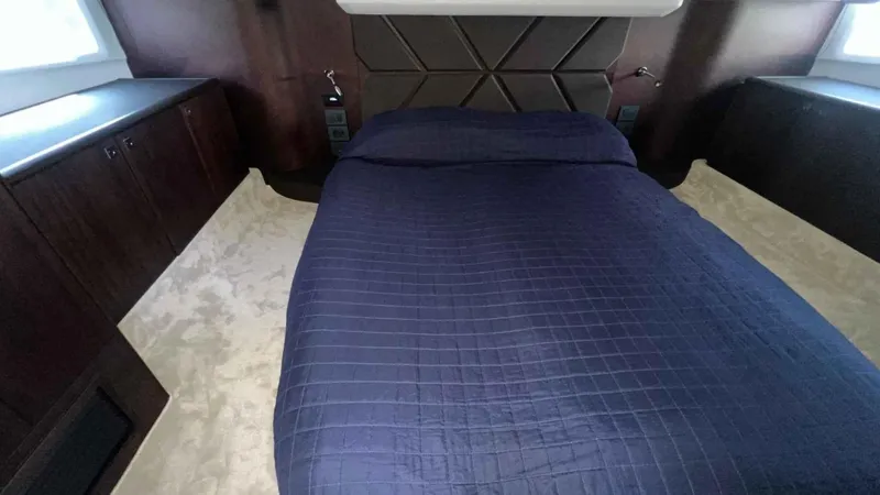  Yacht Photos Pics Luxurious bedroom interior of 2024 Galeon 410 HTC yacht with dark wood accents.