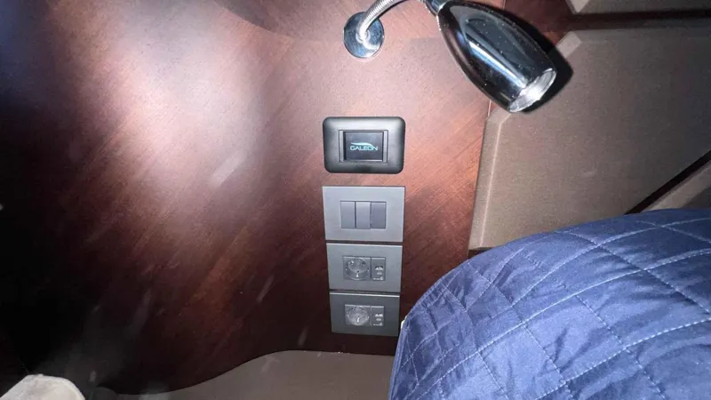  Yacht Photos Pics 2024 Galeon 410 HTC interior with switches and reading light on wooden panel.