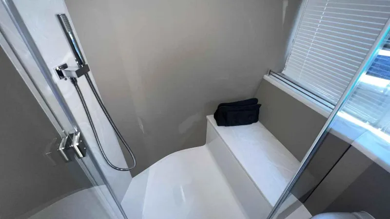  Yacht Photos Pics Modern bathroom interior in 2024 Galeon 410 HTC yacht, featuring sleek shower and seating area.