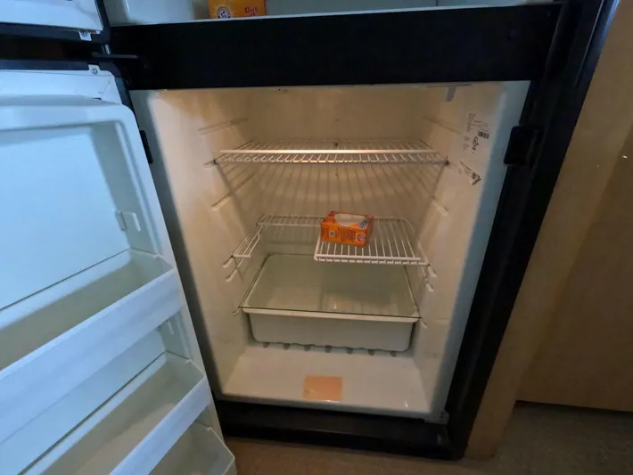 Callie B Yacht Photos Pics Open fridge on 2001 Sea Ray 400 Sedan Bridge, containing a box of baking soda.