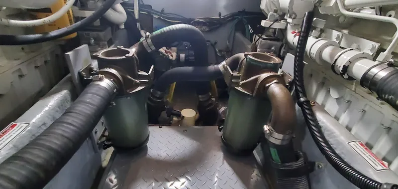 Callie B Yacht Photos Pics Engine room of 2001 Sea Ray 400 Sedan Bridge with visible hoses and components.