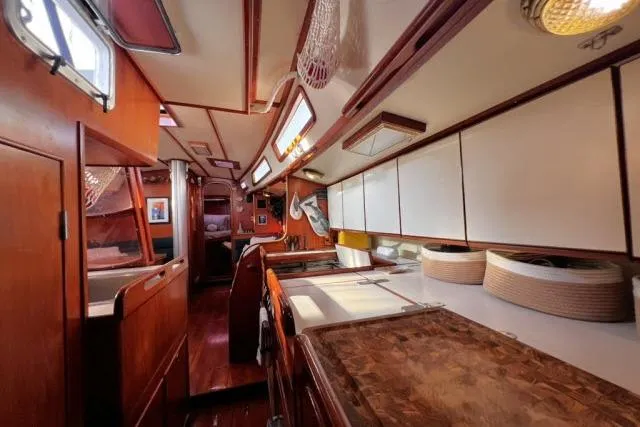 Unicorn Yacht Photos Pics Interior of 1988 Hylas Custom 44 yacht, featuring wood cabinetry and spacious layout.