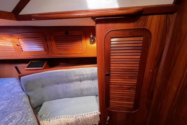 Unicorn Yacht Photos Pics Interior of 1988 Hylas Custom 44 sailboat with wood paneling and cozy seating.