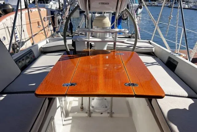 Unicorn Yacht Photos Pics Cockpit of 1988 Hylas Custom 44 sailboat with polished wooden table and seating.