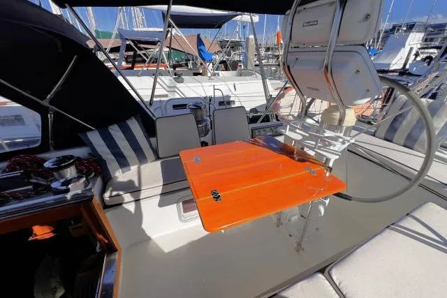 Unicorn Yacht Photos Pics Cockpit of 1988 Hylas Custom 44 sailboat with orange table and striped seating.