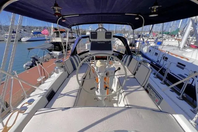 Unicorn Yacht Photos Pics 1988 Hylas Custom 44 sailboat cockpit with steering wheel, docked in marina.