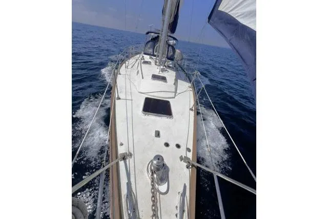 Unicorn Yacht Photos Pics Sailing on a 1988 Hylas Custom 44 yacht, cutting through ocean waves.