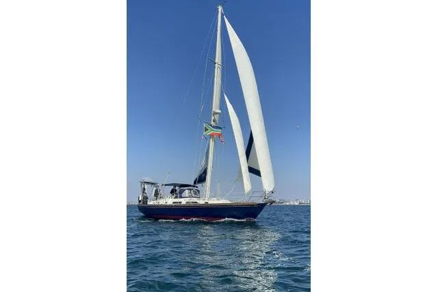 Unicorn Yacht Photos Pics Sailing yacht Hylas Custom 44, 1988 model, cruising on open water under clear skies.