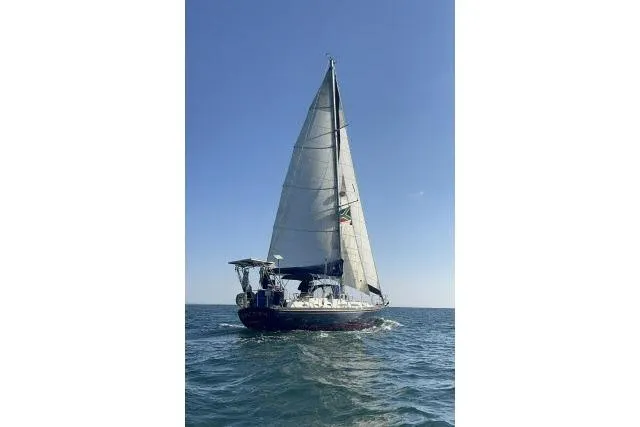 Unicorn Yacht Photos Pics 1988 Hylas Custom 44 sailboat navigating on open sea under clear blue sky.