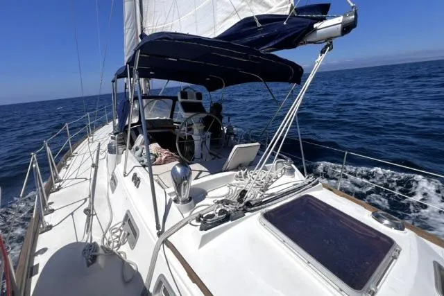 Unicorn Yacht Photos Pics Sailing on 1988 Hylas Custom 44 yacht in open sea under clear blue sky.