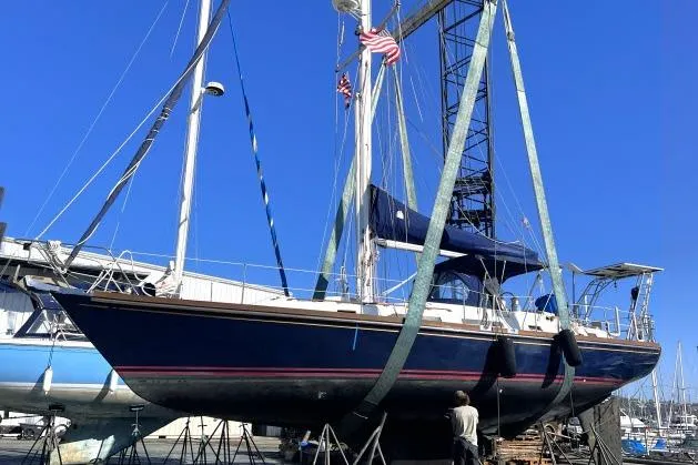 Unicorn Yacht Photos Pics 1988 Hylas Custom 44 sailboat in dry dock, blue hull, marina background.