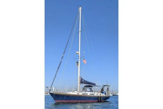 Unicorn Yacht Photos Pics 1988 Hylas Custom 44 sailboat on calm water under clear blue sky.