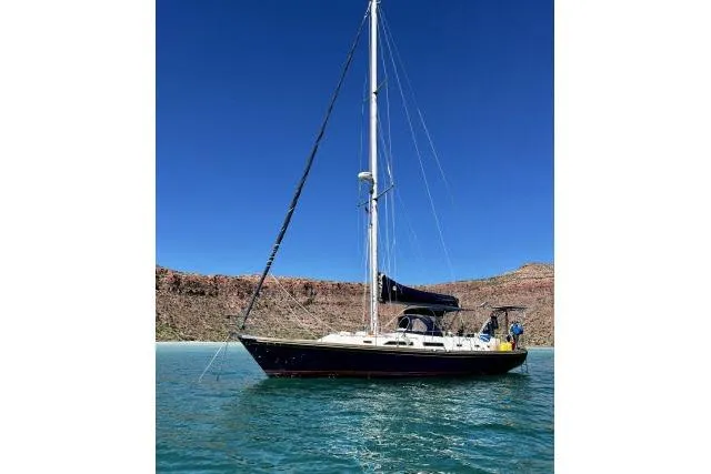 Unicorn Yacht Photos Pics 1988 Hylas Custom 44 sailboat on calm water under clear blue sky.