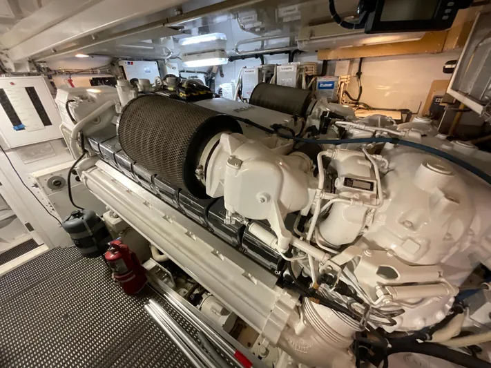 Temptation Yacht Photos Pics Engine room of 2008 Hatteras 77 Convertible yacht, showcasing powerful machinery and components.