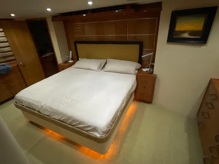 Temptation Yacht Photos Pics Luxurious bedroom interior of 2008 Hatteras 77 Convertible yacht with ambient lighting.