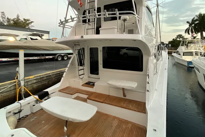 Temptation Yacht Photos Pics 2008 Hatteras 77 Convertible yacht with spacious deck and seating area.