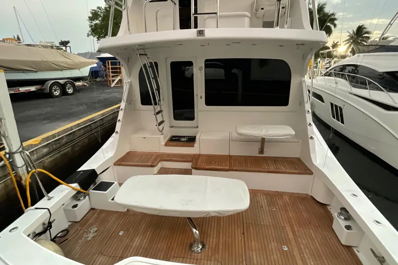 Temptation Yacht Photos Pics 2008 Hatteras 77 Convertible yacht with spacious deck and seating area.