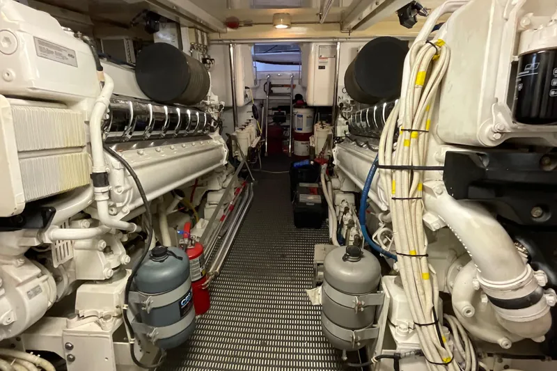 Temptation Yacht Photos Pics Engine room of 2008 Hatteras 77 Convertible yacht, showcasing dual engines and equipment.