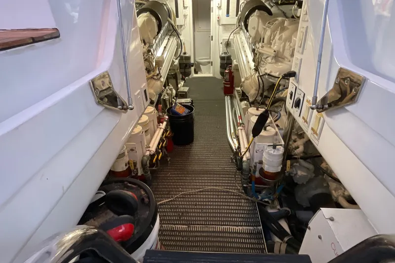 Temptation Yacht Photos Pics Engine room of 2008 Hatteras 77 Convertible yacht, showcasing dual engines and equipment.