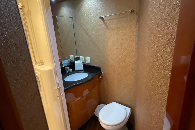 Temptation Yacht Photos Pics Bathroom interior of 2008 Hatteras 77 Convertible yacht with modern fixtures.