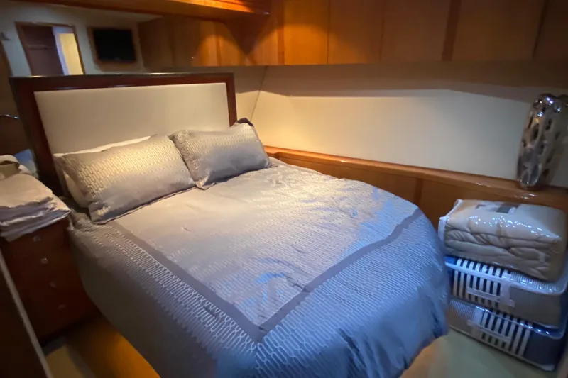 Temptation Yacht Photos Pics Luxurious bedroom interior of 2008 Hatteras 77 Convertible yacht with elegant bedding.