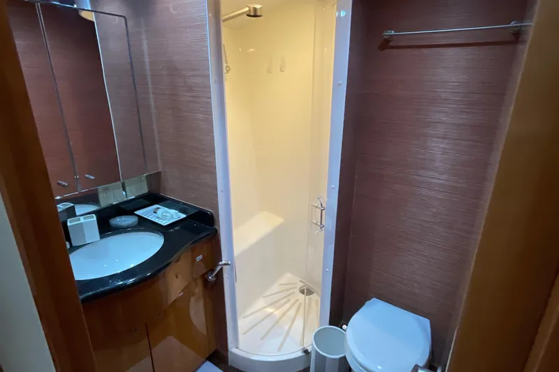 Temptation Yacht Photos Pics Bathroom interior of 2008 Hatteras 77 Convertible yacht with shower, sink, and toilet.