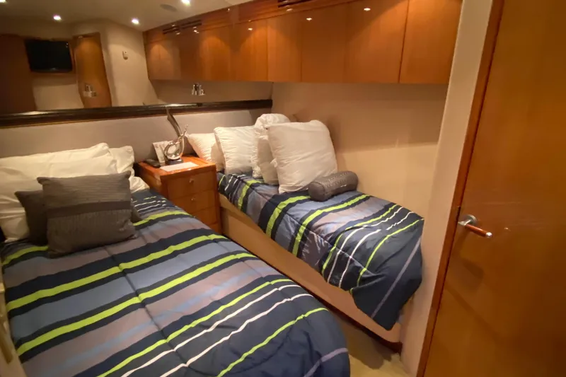 Temptation Yacht Photos Pics Interior of 2008 Hatteras 77 Convertible yacht with twin beds and modern decor.