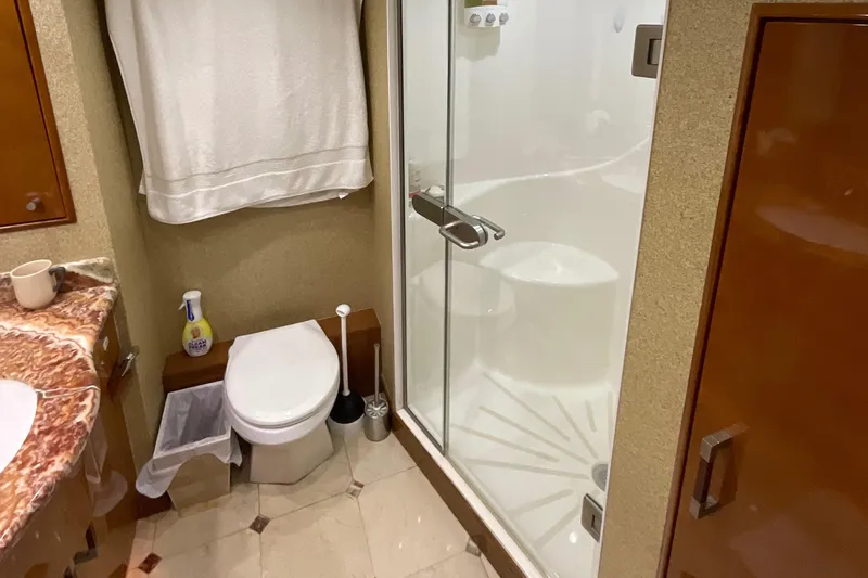 Temptation Yacht Photos Pics Bathroom interior of 2008 Hatteras 77 Convertible yacht with shower and toilet.