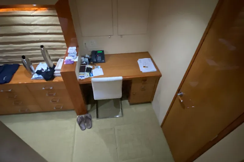 Temptation Yacht Photos Pics Office space inside 2008 Hatteras 77 Convertible yacht with desk, chair, and storage.