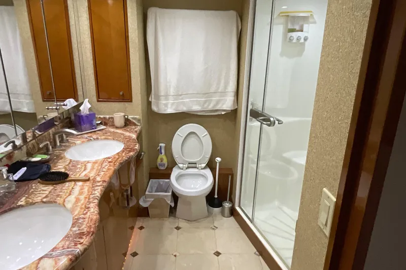 Temptation Yacht Photos Pics Luxurious bathroom in a 2008 Hatteras 77 Convertible yacht with dual sinks and shower.