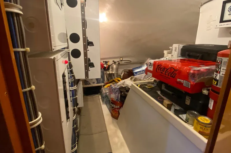 Temptation Yacht Photos Pics Storage area inside 2008 Hatteras 77 Convertible yacht, featuring supplies and equipment.