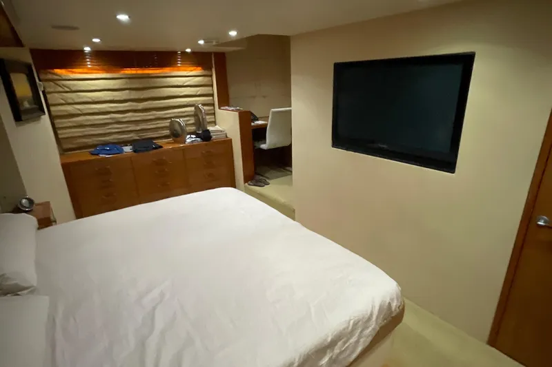 Temptation Yacht Photos Pics Luxurious bedroom interior of 2008 Hatteras 77 Convertible yacht with modern amenities.