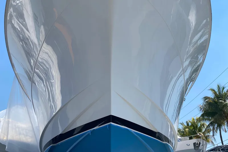 Temptation Yacht Photos Pics Front view of a 2008 Hatteras 77 Convertible yacht with a sleek hull design.