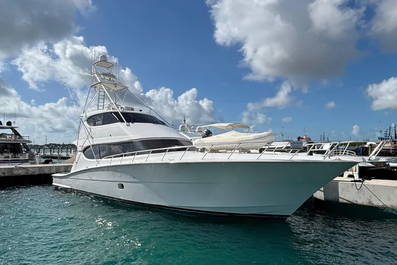 Temptation Yacht Photos Pics 2008 Hatteras 77 Convertible yacht docked in a marina under a partly cloudy sky.