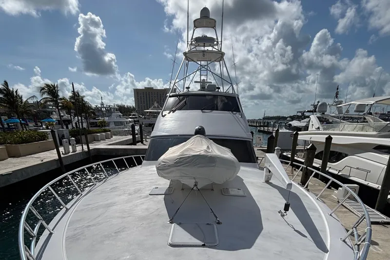 Temptation Yacht Photos Pics 2008 Hatteras 77 Convertible yacht docked at marina under cloudy sky.