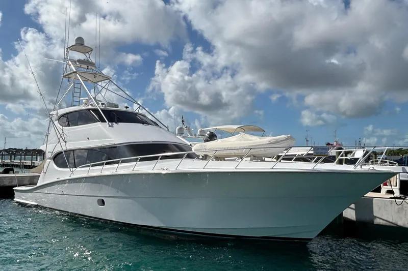 Temptation Yacht Photos Pics 2008 Hatteras 77 Convertible yacht docked under cloudy sky.