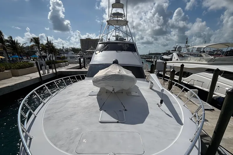 Temptation Yacht Photos Pics 2008 Hatteras 77 Convertible yacht docked at marina under cloudy sky.