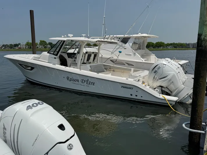 Yacht Photos Pics 2022 Pursuit S 378 Sport boat docked, featuring twin outboard engines.