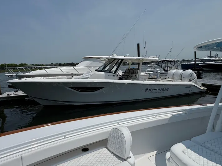  Yacht Photos Pics 2022 Pursuit S 378 Sport boat docked at marina, side view.