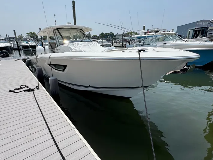  Yacht Photos Pics 2022 Pursuit S 378 Sport boat docked at marina, sleek design, white exterior.