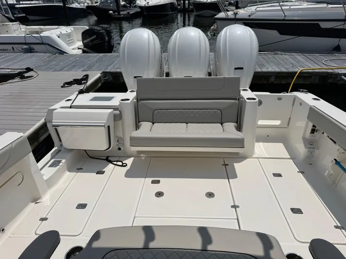  Yacht Photos Pics 2022 Pursuit S 378 Sport boat with triple engines and spacious deck at marina.