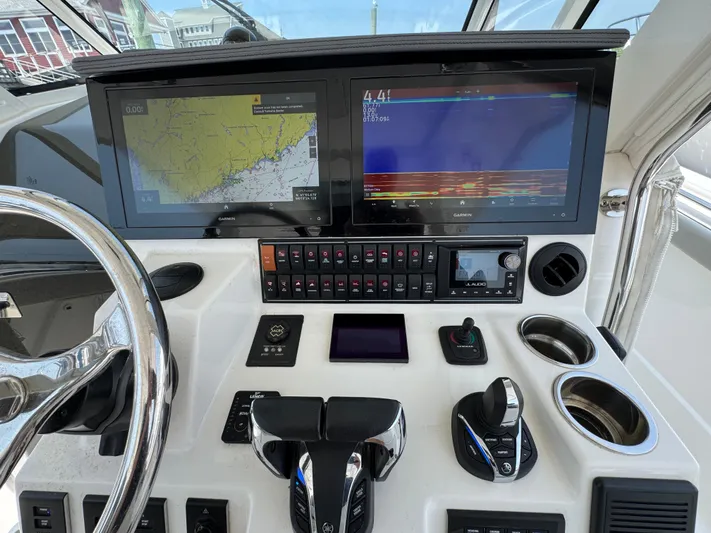  Yacht Photos Pics Control panel of 2022 Pursuit S 378 Sport boat with navigation screens and controls.