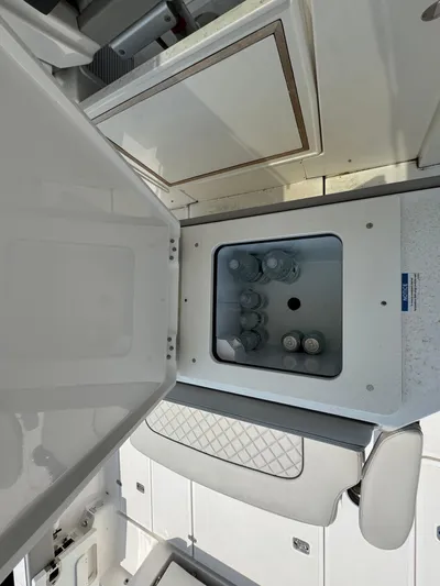  Yacht Photos Pics Interior view of 2022 Pursuit S 378 Sport boat with built-in cooler containing drinks.