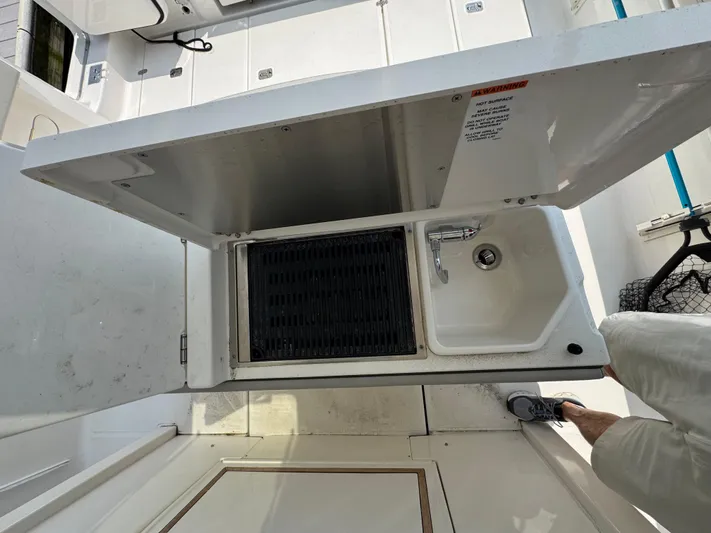  Yacht Photos Pics 2022 Pursuit S 378 Sport boat sink and storage compartment.