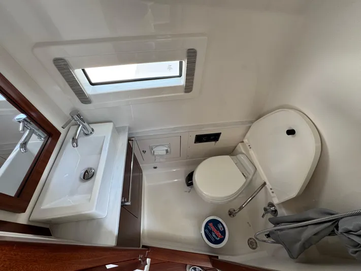  Yacht Photos Pics 2022 Pursuit S 378 Sport boat bathroom with sink, toilet, and window.
