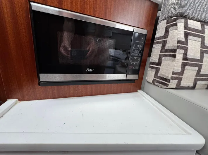  Yacht Photos Pics Built-in microwave in 2022 Pursuit S 378 Sport boat interior.