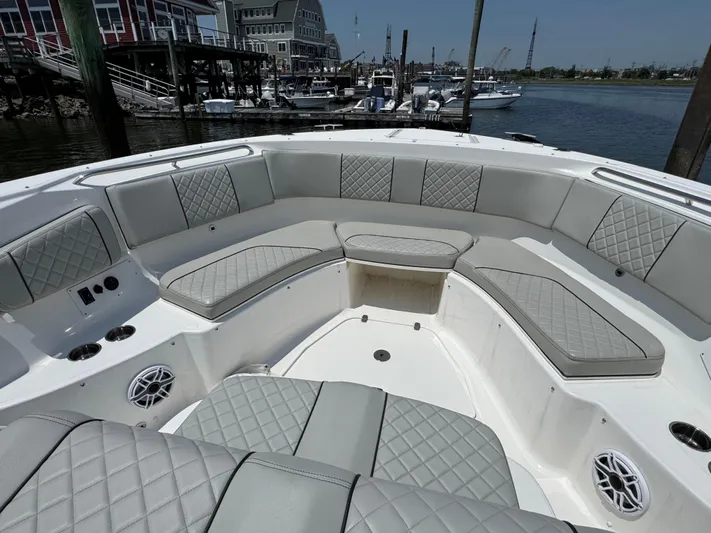  Yacht Photos Pics Luxurious seating area on 2022 Pursuit S 378 Sport boat, docked at marina.
